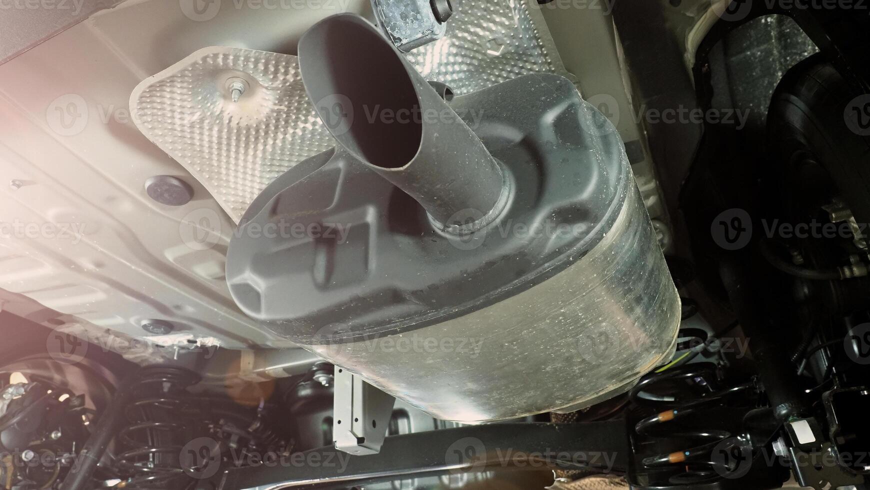 Under car exhaust pipe suspension. Automotive mufflers. Inspection of car for Defects. Metal fittings and pipes for the muffler. Suspension elements and exhaust system. Auto parts and car service photo
