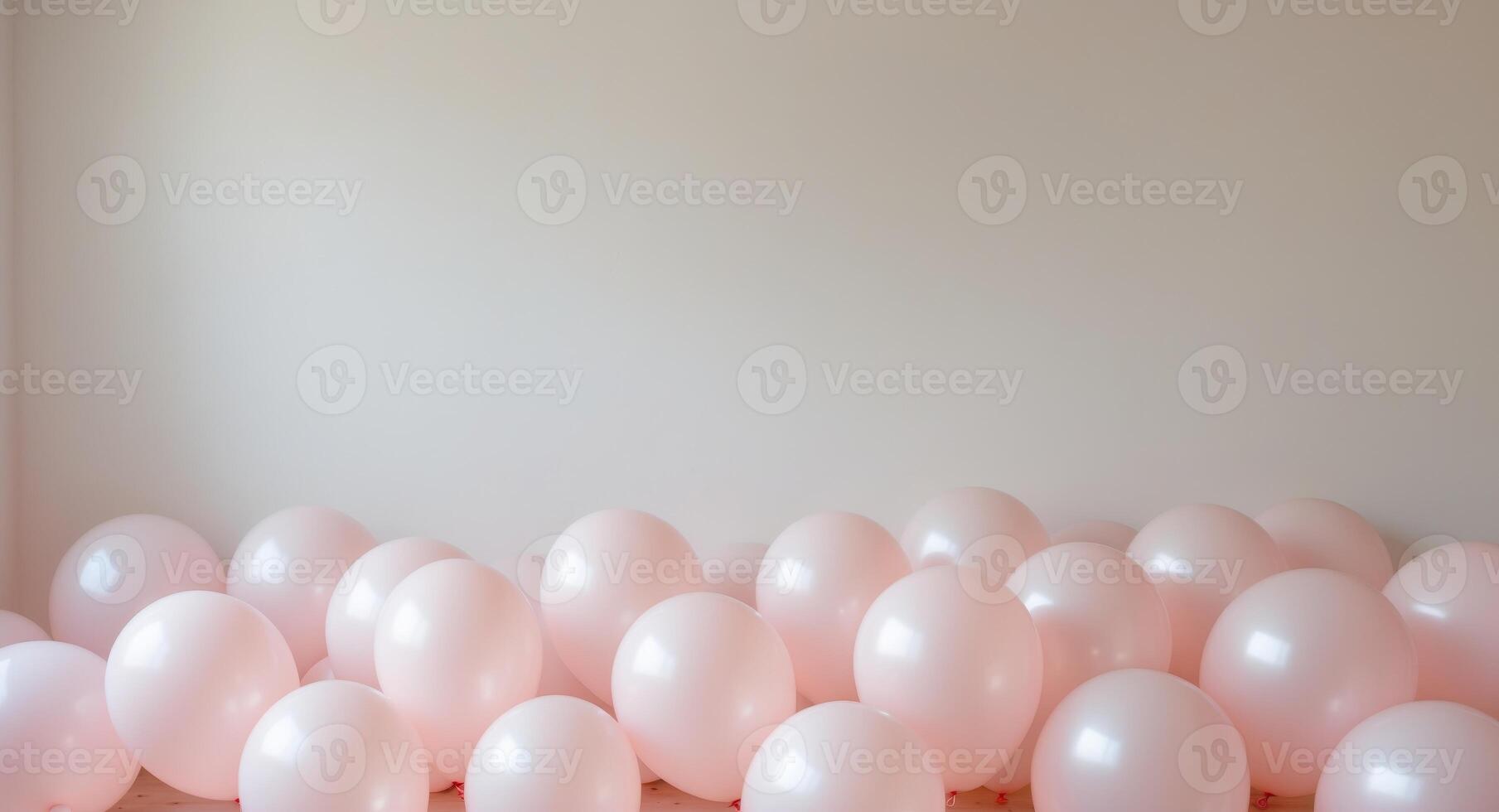 Pink balloons in a room with a white wall photo