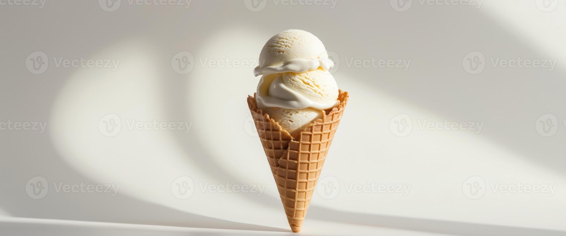 A delicious scoop of creamy white vanilla ice cream in a waffle cone. photo