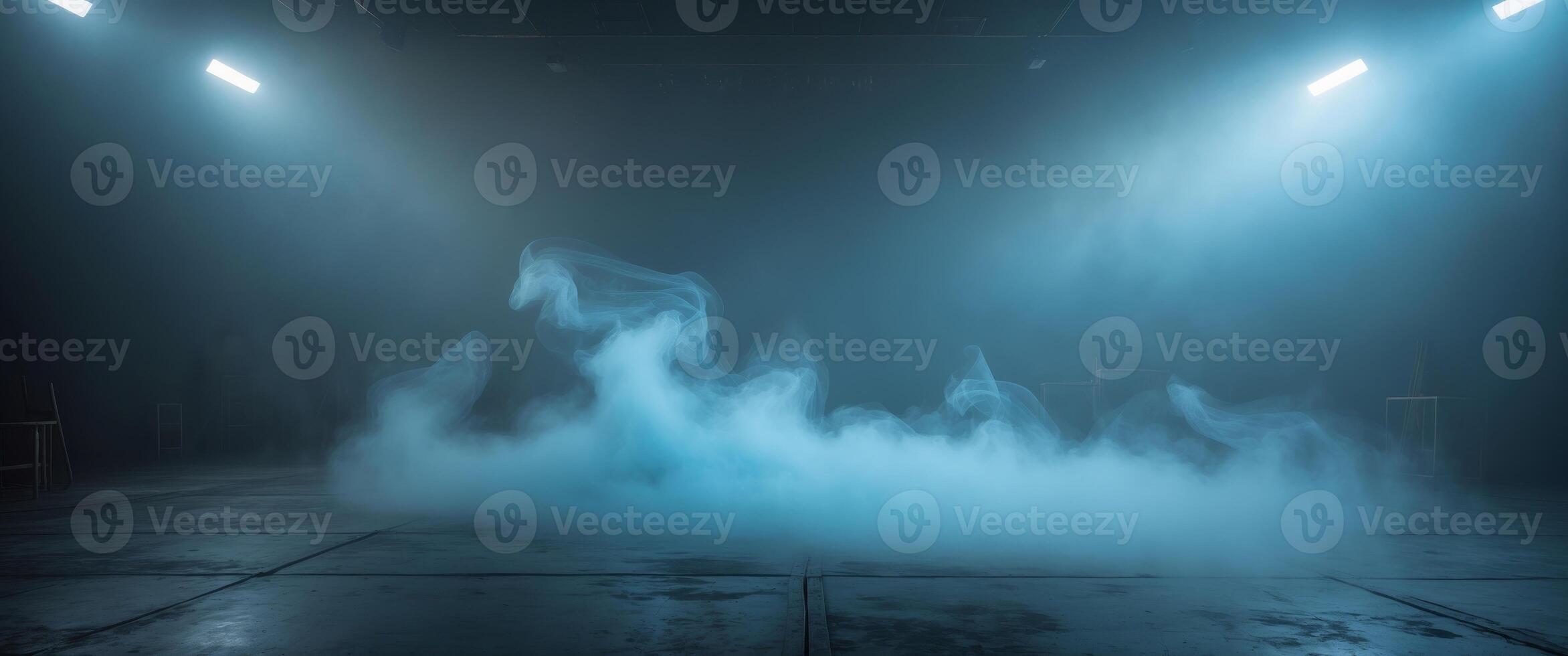 Mysterious blue mist envelops an empty stage in a dimly lit atmosphere creating an eerie ambiance photo