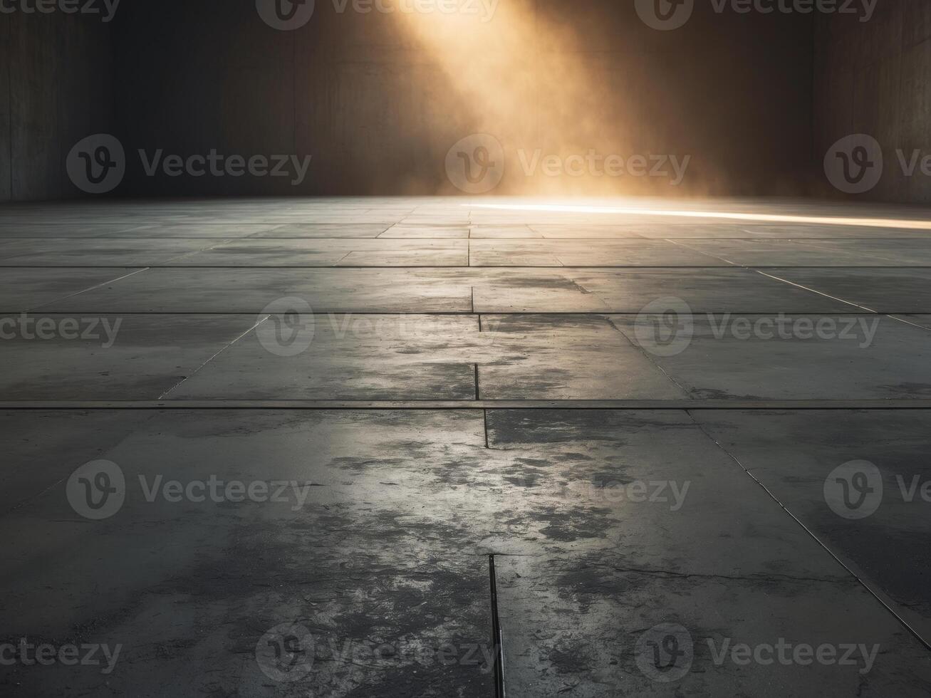 Empty concrete floor illuminated by warm light beam in dark room. photo