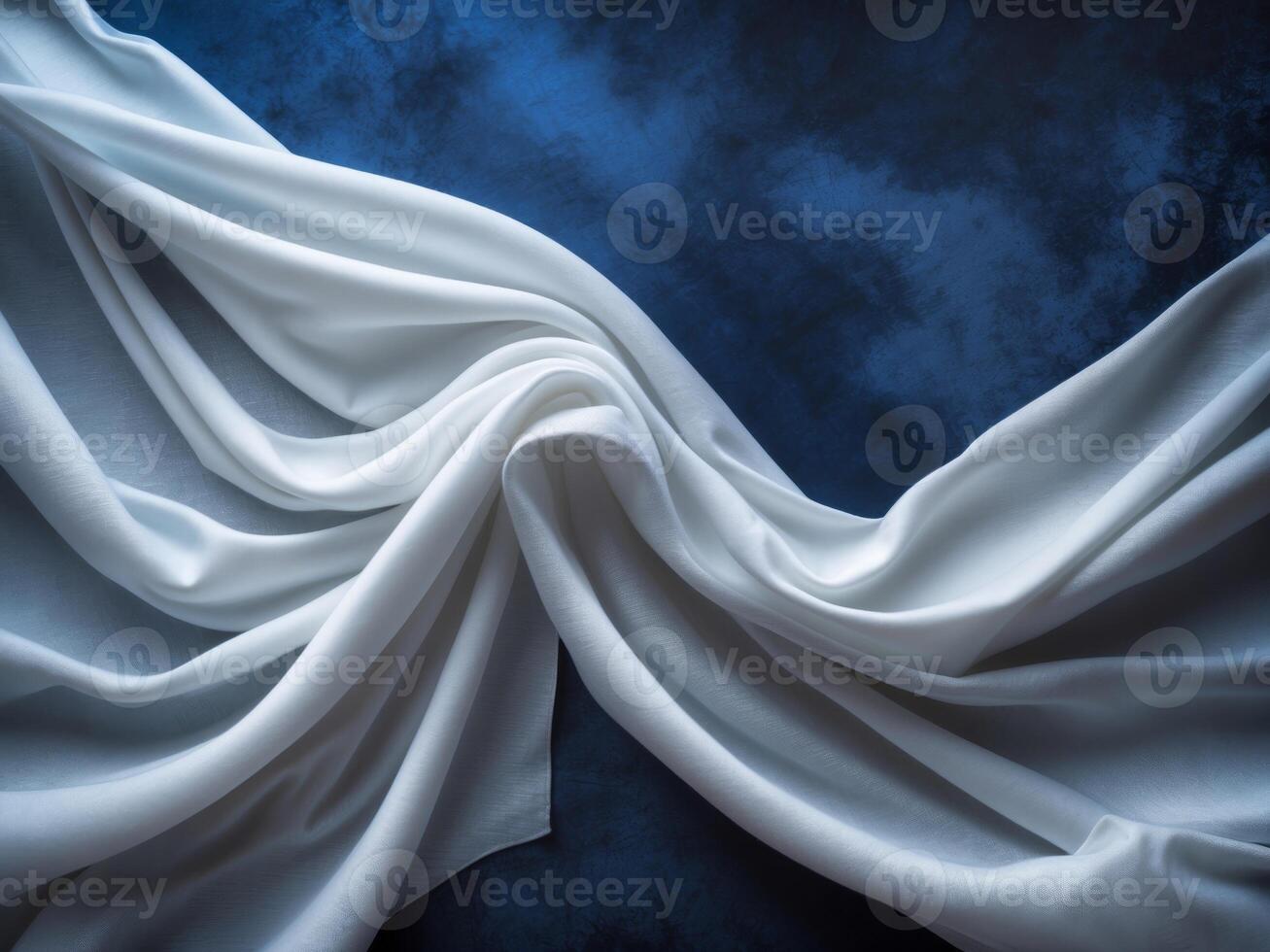 Elegant White Fabric Draped Over Deep Blue Surface for Luxury and Sophistication in Textile and Textile Design Projects. photo