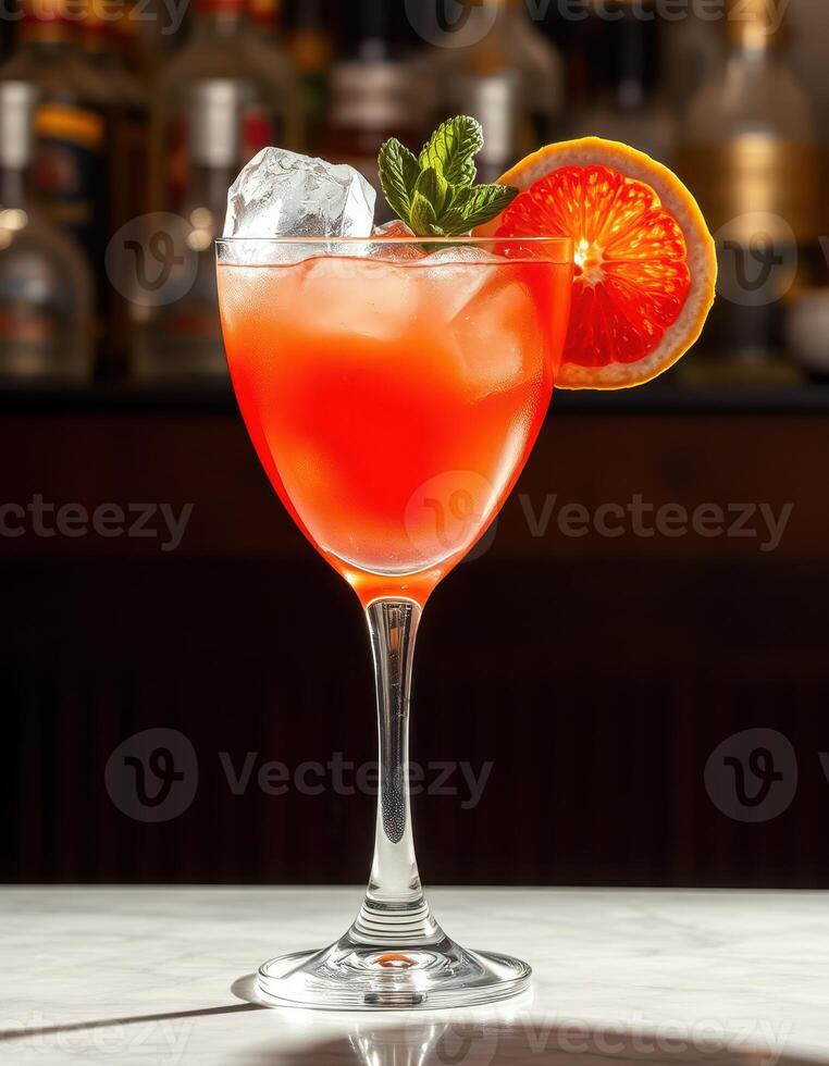 Refreshing cocktail garnished with citrus and mint served in an elegant glass at a modern bar during evening hours photo