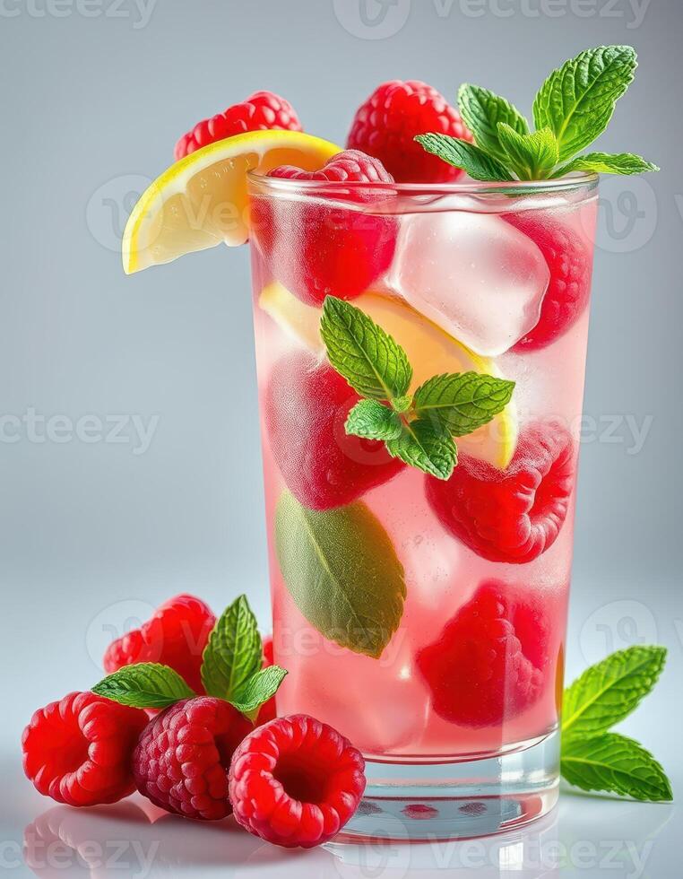 Refreshing raspberry lemonade served in a glass with mint leaves and ice during a sunny afternoon photo