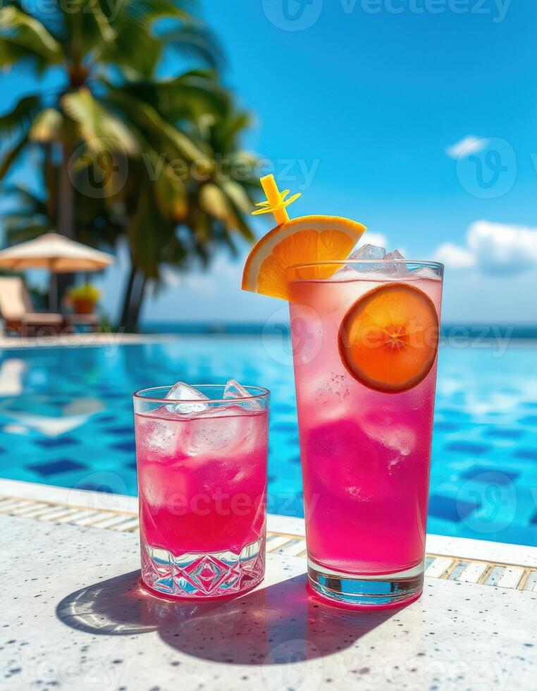 Bright tropical drinks by the pool in a sunny resort setting under a clear sky photo