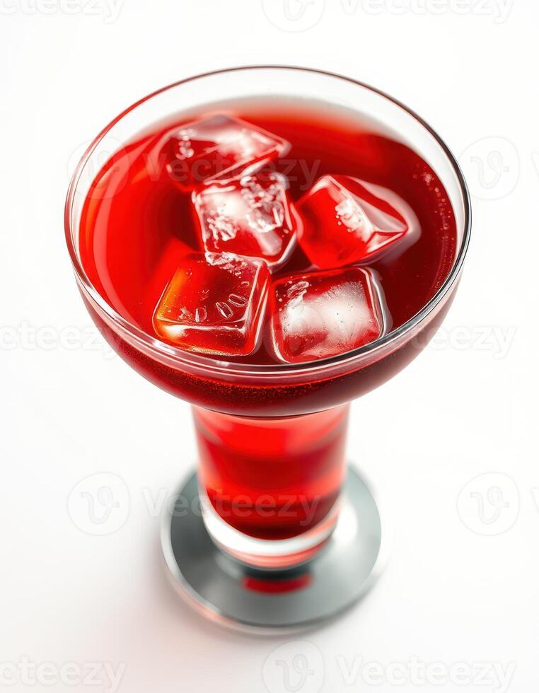 Refreshing red beverage served in an elegant glass with ice cubes on a bright background during a summer afternoon photo