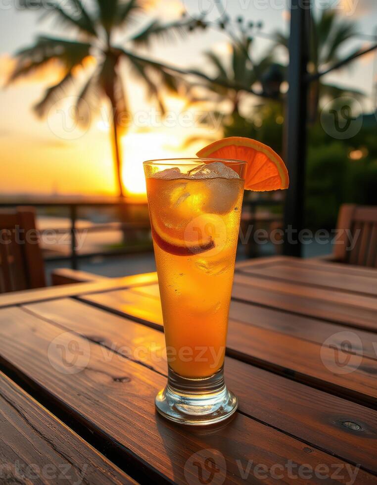 Refreshing beverage served at sunset in a tropical setting near palm trees photo