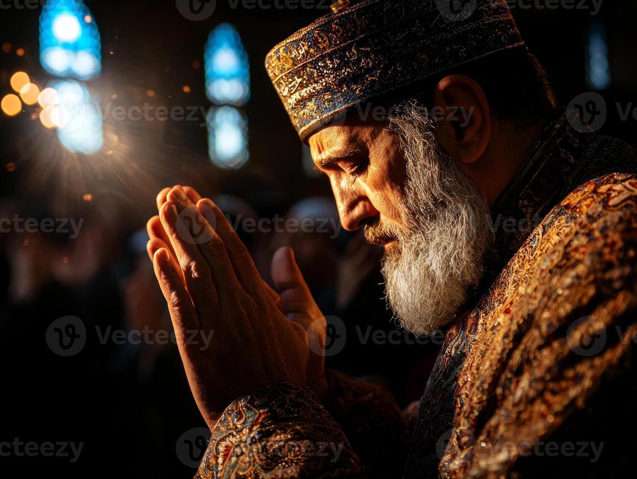 close up of Imam standing in mosque hands raised in preparation for Takbir during Maghrib prayer. Worshippers behind him are immersed in silent devotion photo