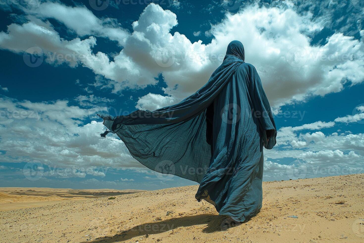 man dressed in traditional Islamic attire his jubba billowing in wind stands alone in expansive desert dynamic sky embodying peaceful moment of reflection and unity photo