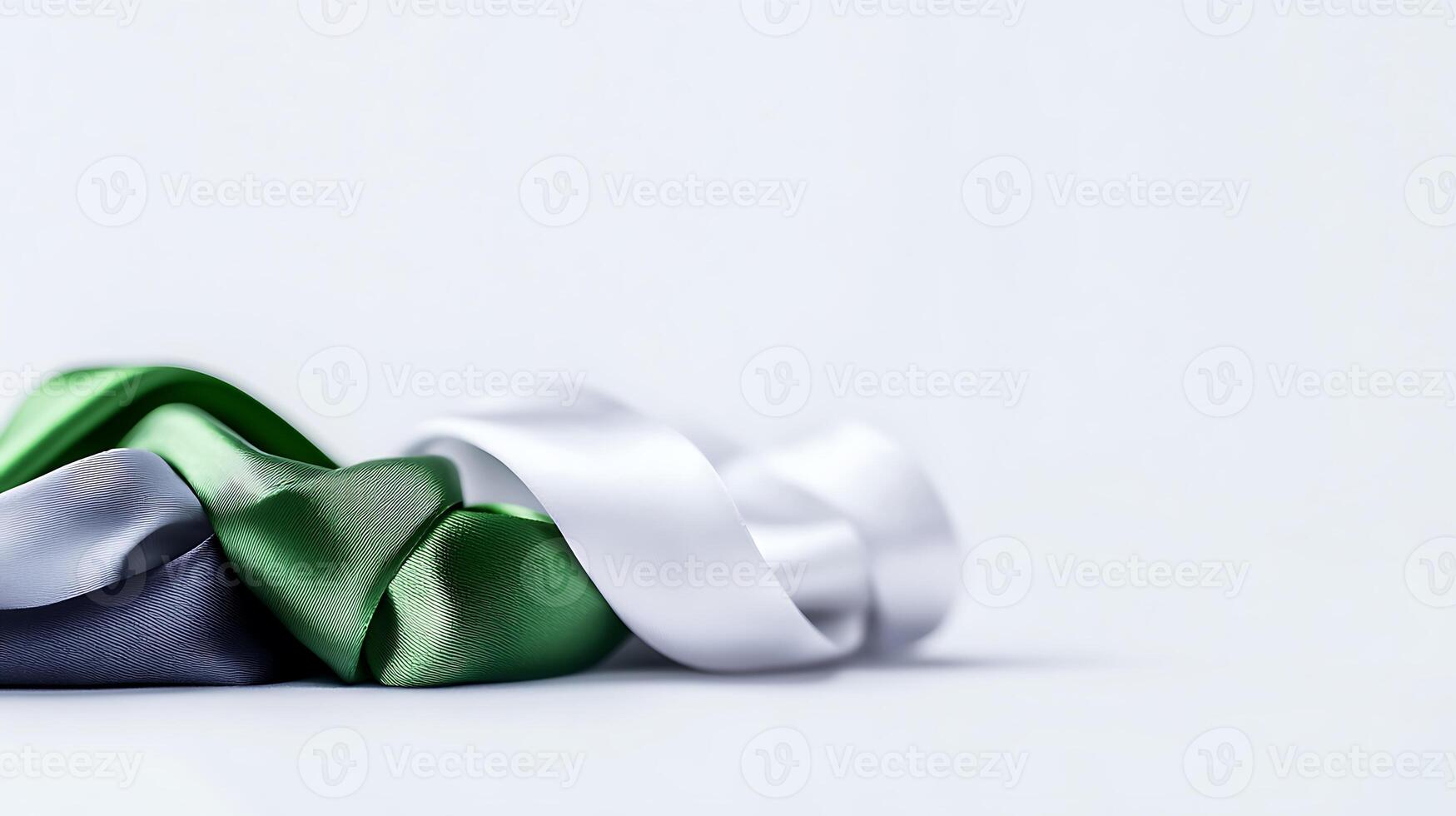 A collection of colorful satin ribbons arranged elegantly on a soft white background photo