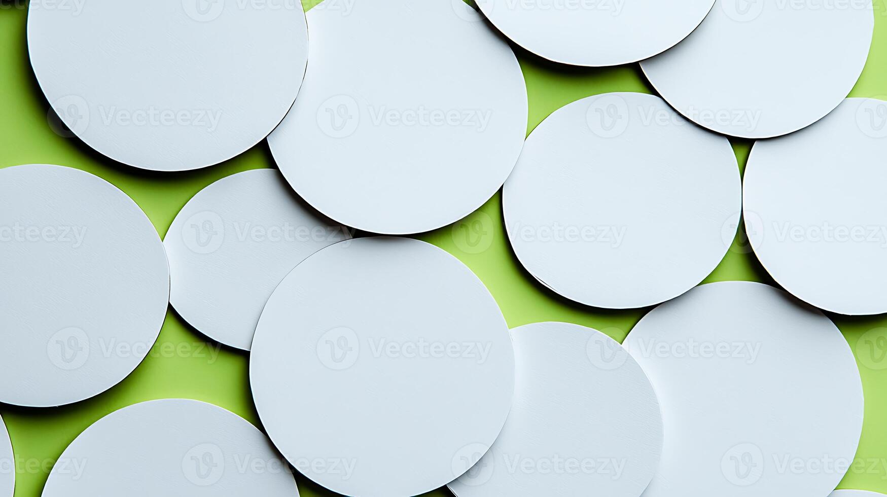 A collection of blank circular paper cutouts scattered on a vibrant green background photo