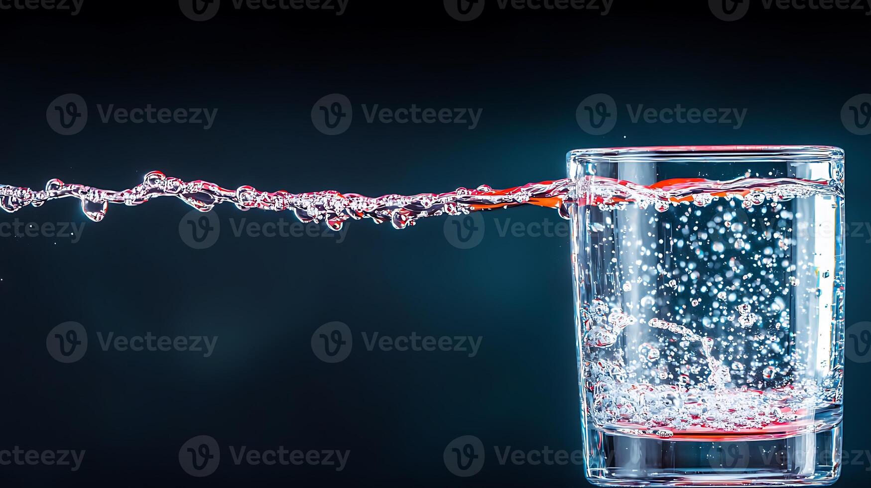 A glass of water with a splash of red liquid photo