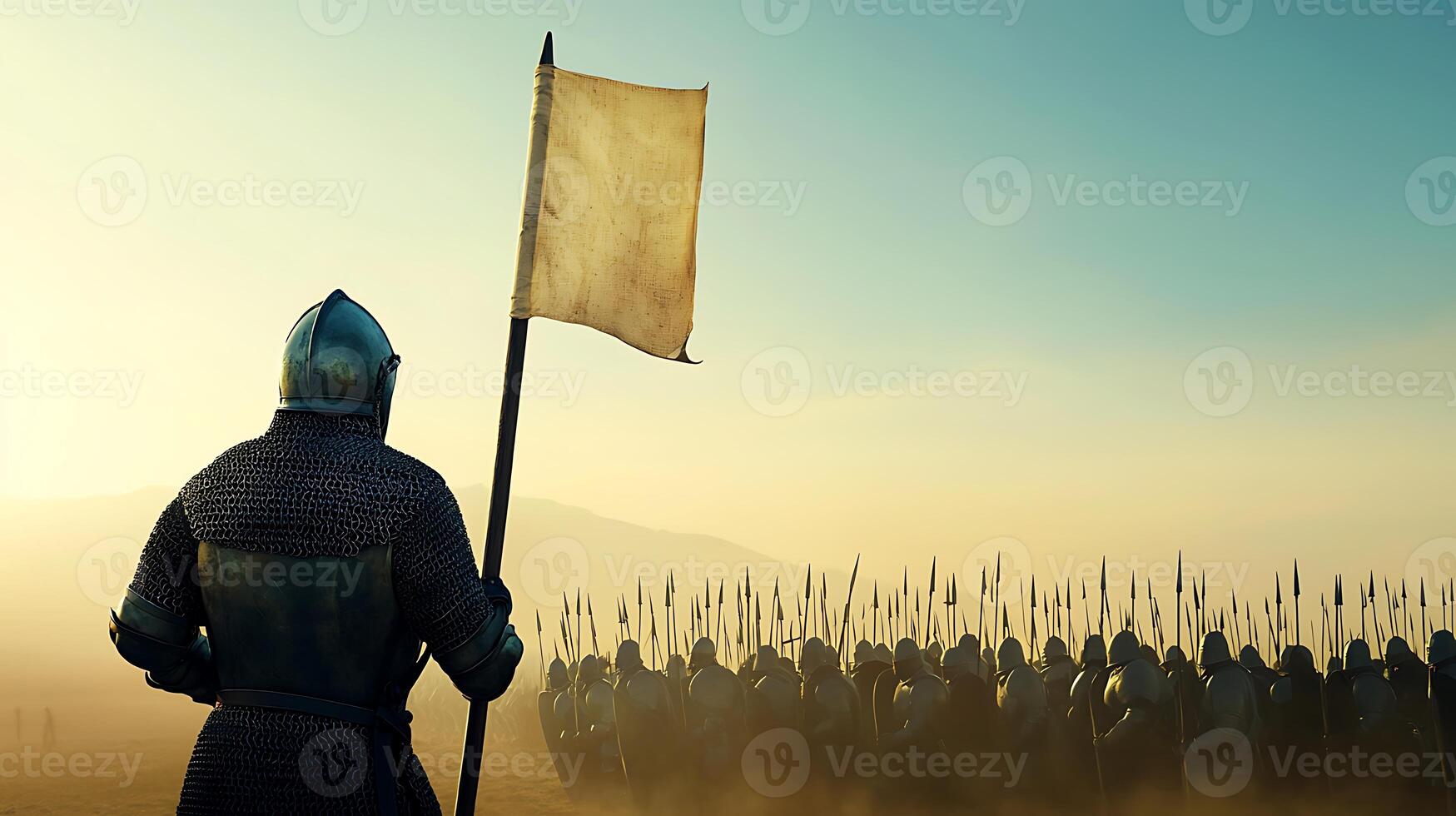 A man in armor holding a flag in front of a group of soldiers photo