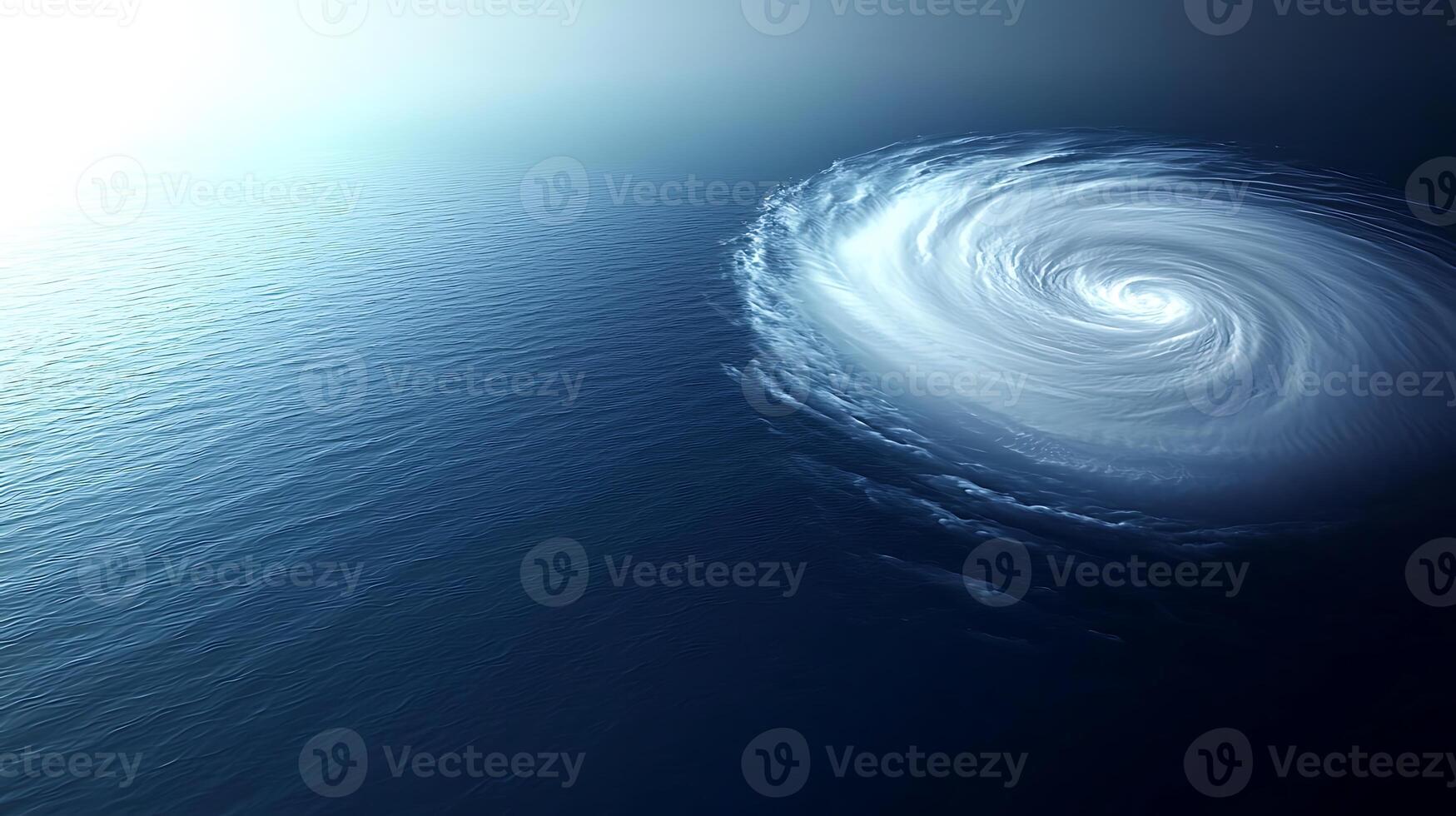 A large white circular vortex is seen in the ocean photo