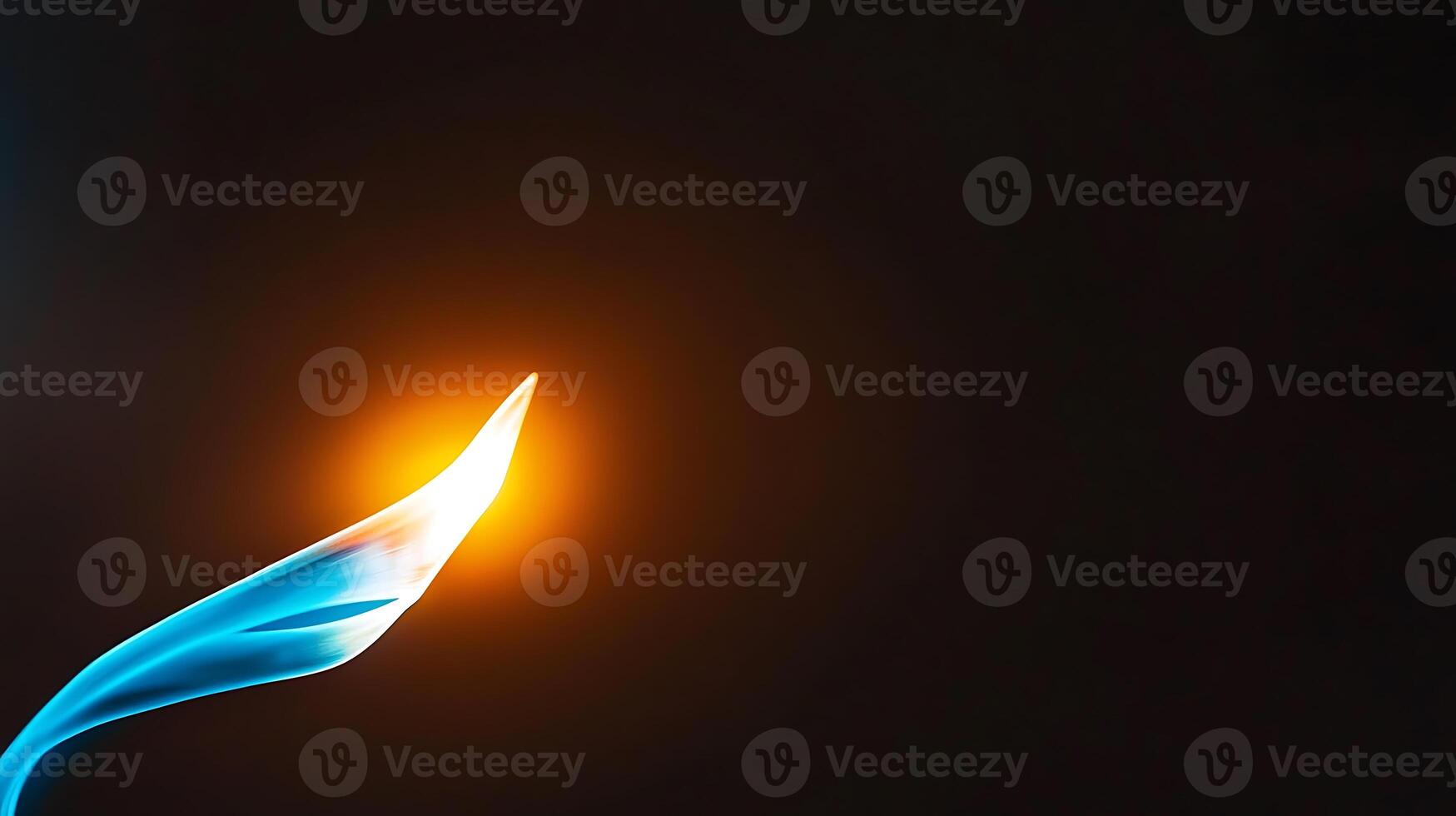 A blue flame is burning in the dark photo
