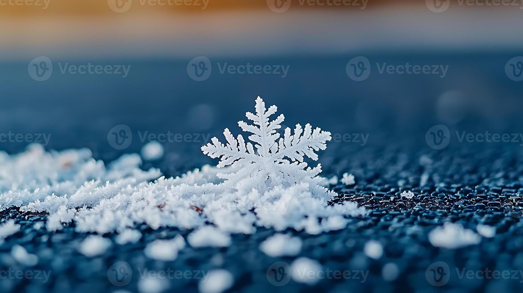 A snowflake is sitting on top of a blue surface photo