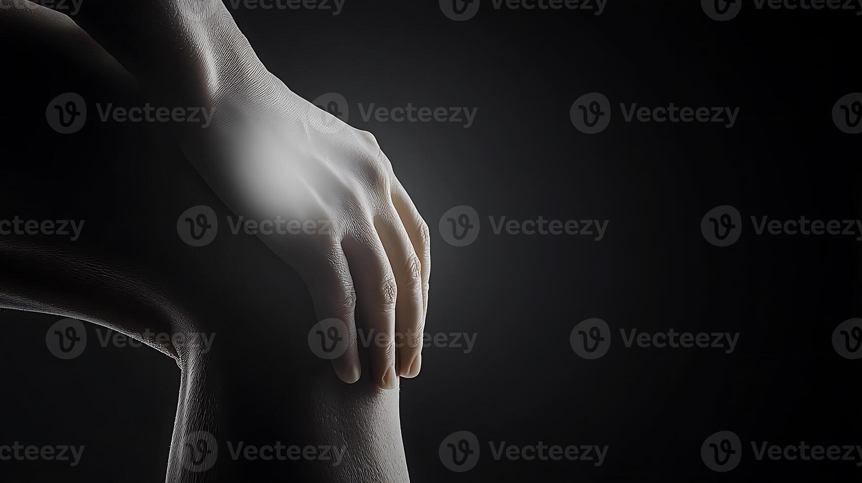 A person with knee pain on a black background photo