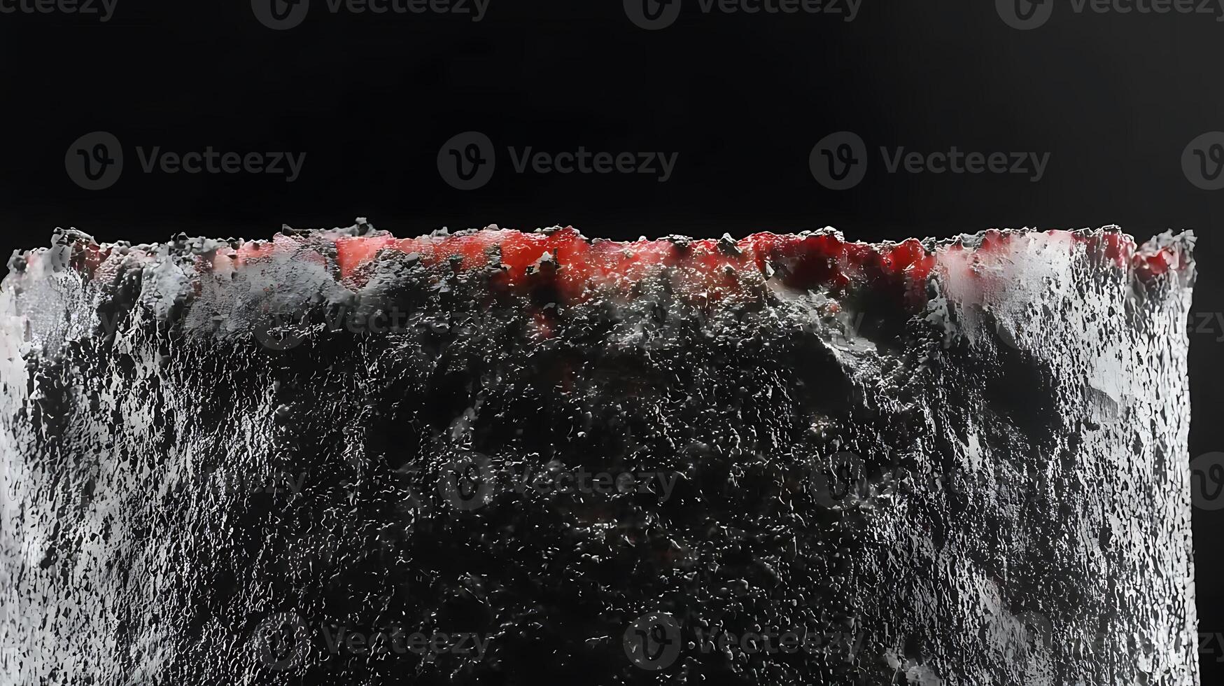 Close-up of a textured surface with red and black elements, creating a dramatic contrast photo