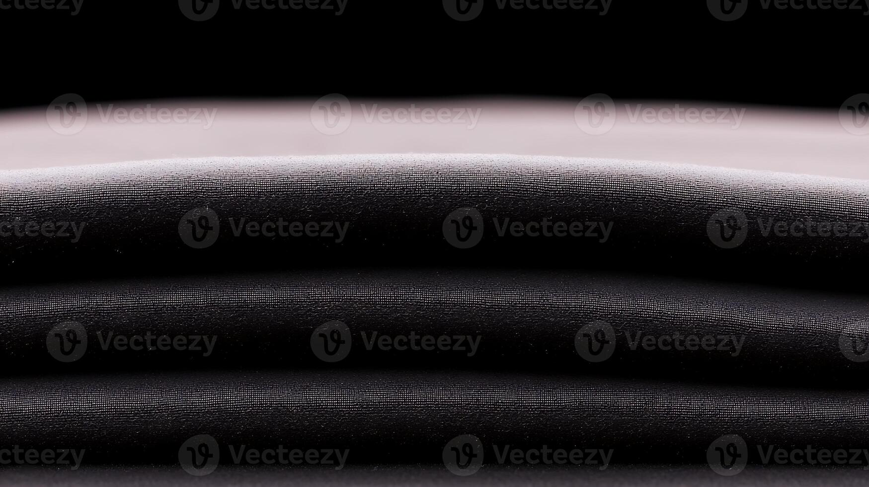 A stack of black sheets on a black background photo