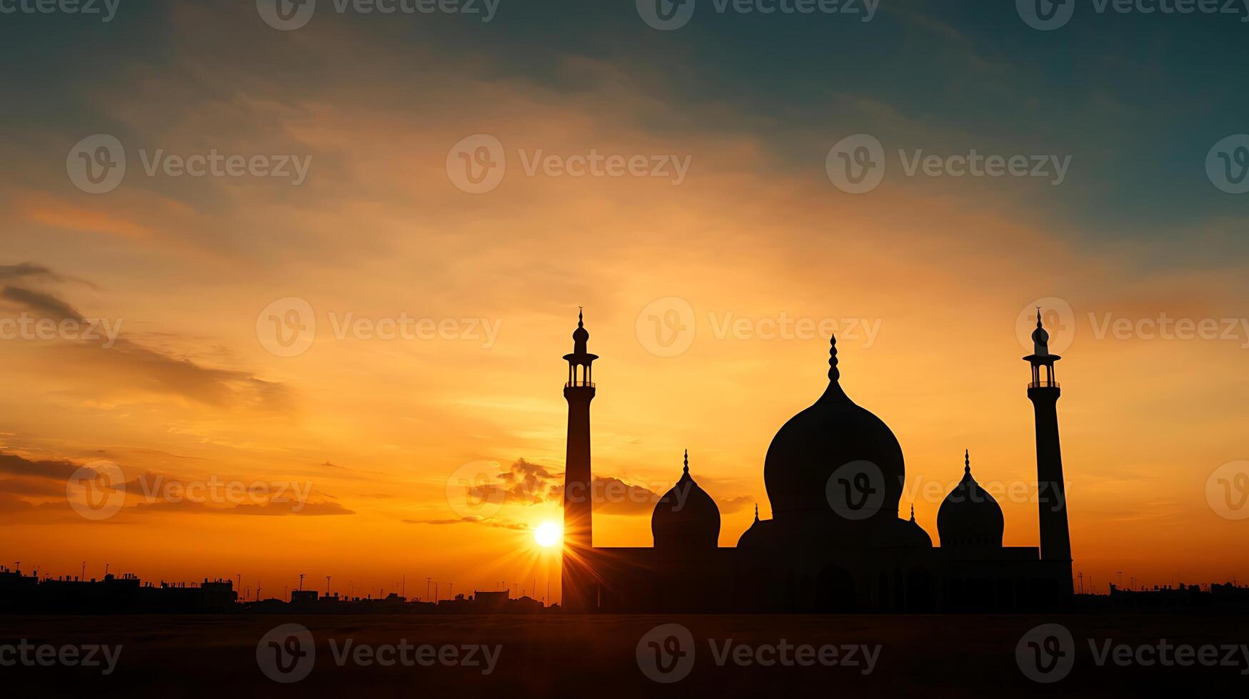 The sun sets behind a mosque in the middle of a field photo