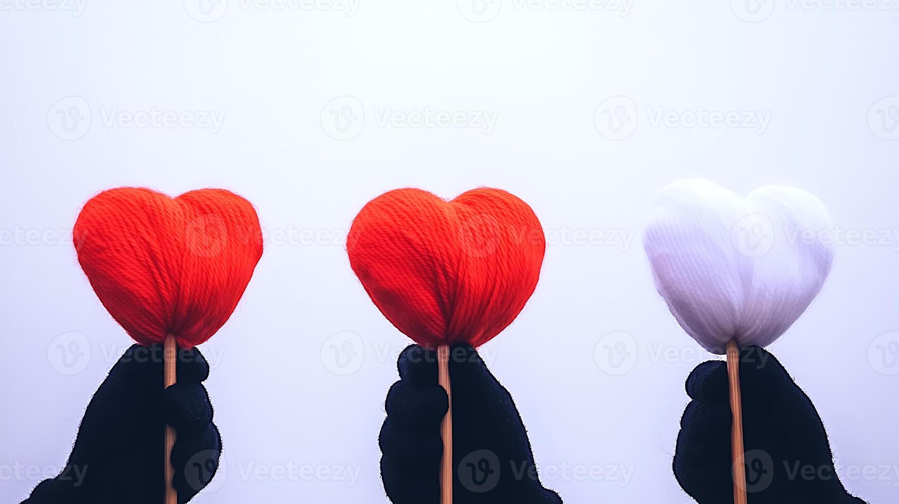 Three people holding red and white hearts photo