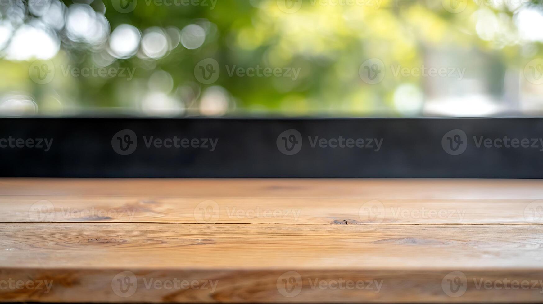 Wooden tabletop in a bright cafe setting with blurred greenery in the background photo