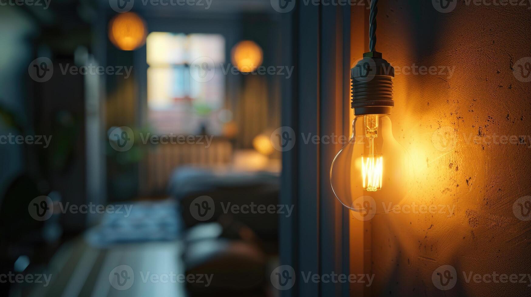 Light bulb in a socket casting warm glow photo