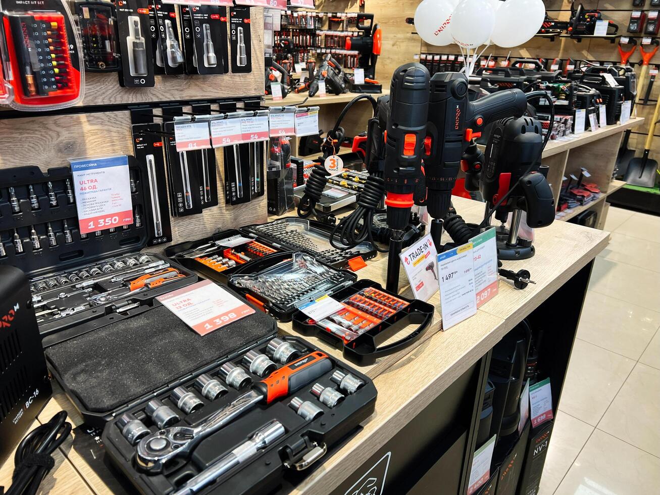 Kyiv, Ukraine - February 04, 2025 Various tools and power equipment displayed on a store shelf for sale. photo