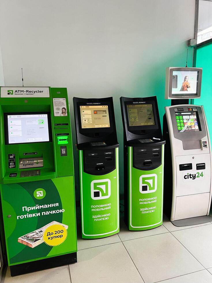 Kyiv, Ukraine - February 04, 2025 Banking machines for currency exchanges and utility payments lined in a modern kiosk photo