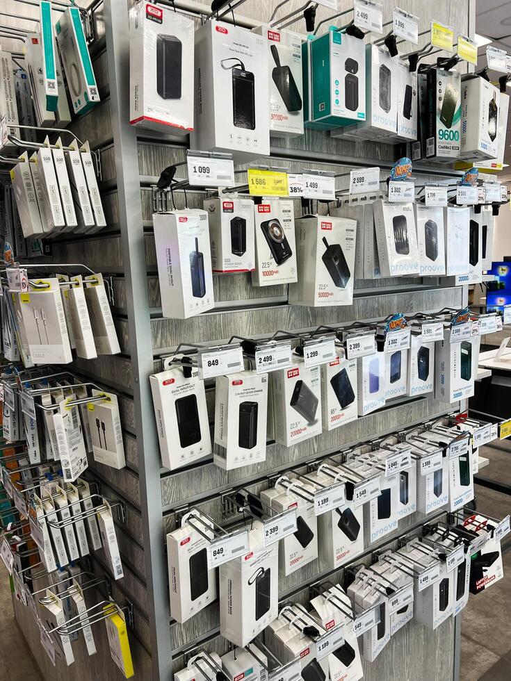 Kyiv, Ukraine - February 04, 2025 Display of electronic devices and accessories organized neatly on retail store shelves photo