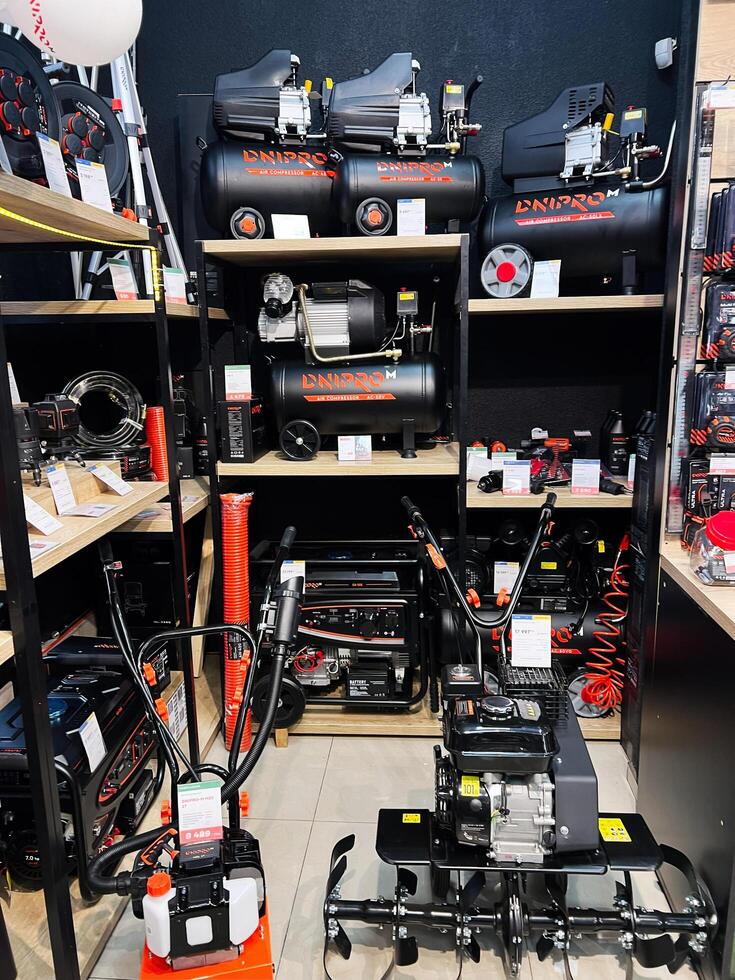 Kyiv, Ukraine - February 04, 2025 Power tools and machinery organized on display shelves in a showroom photo
