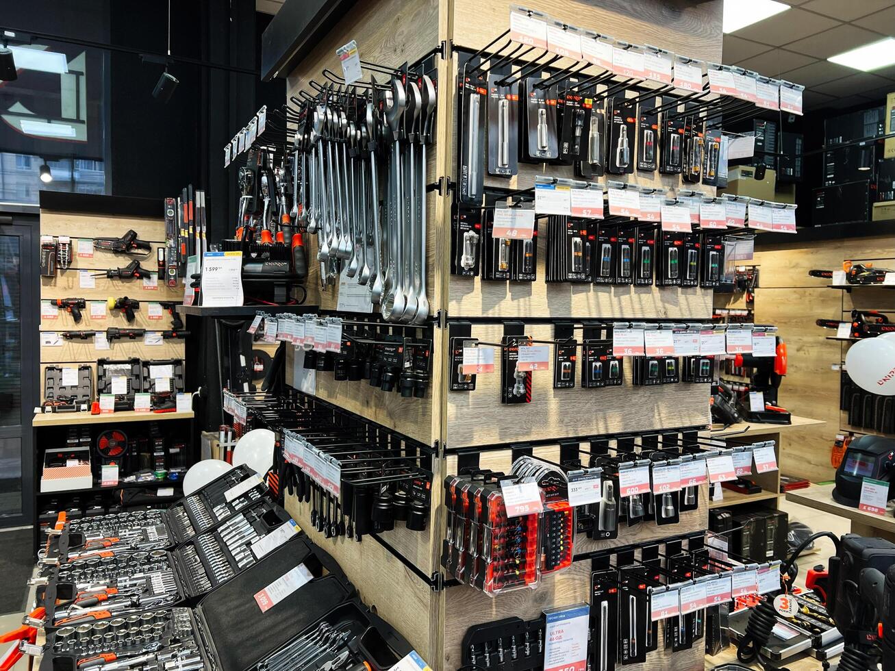 Kyiv, Ukraine - February 04, 2025 Assorted hand tools organized in tool store display with various sets and kits photo
