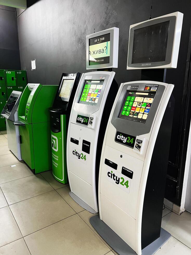 Kyiv, Ukraine - February 04, 2025 Row of modern interactive payment kiosks and ATMs in public space photo