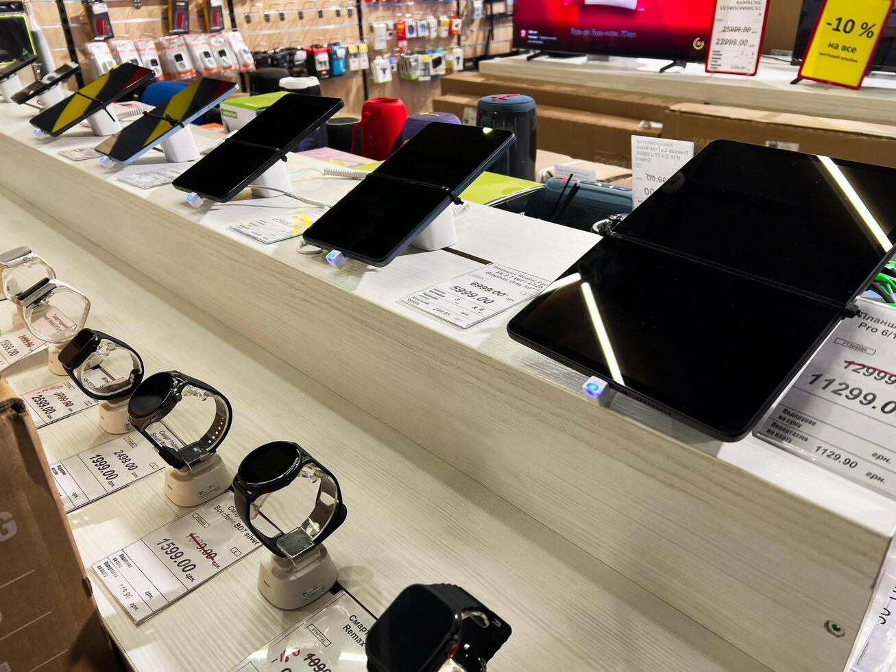 Kyiv, Ukraine - February 04, 2025 Display of smart watches and foldable phones in a modern electronics store photo