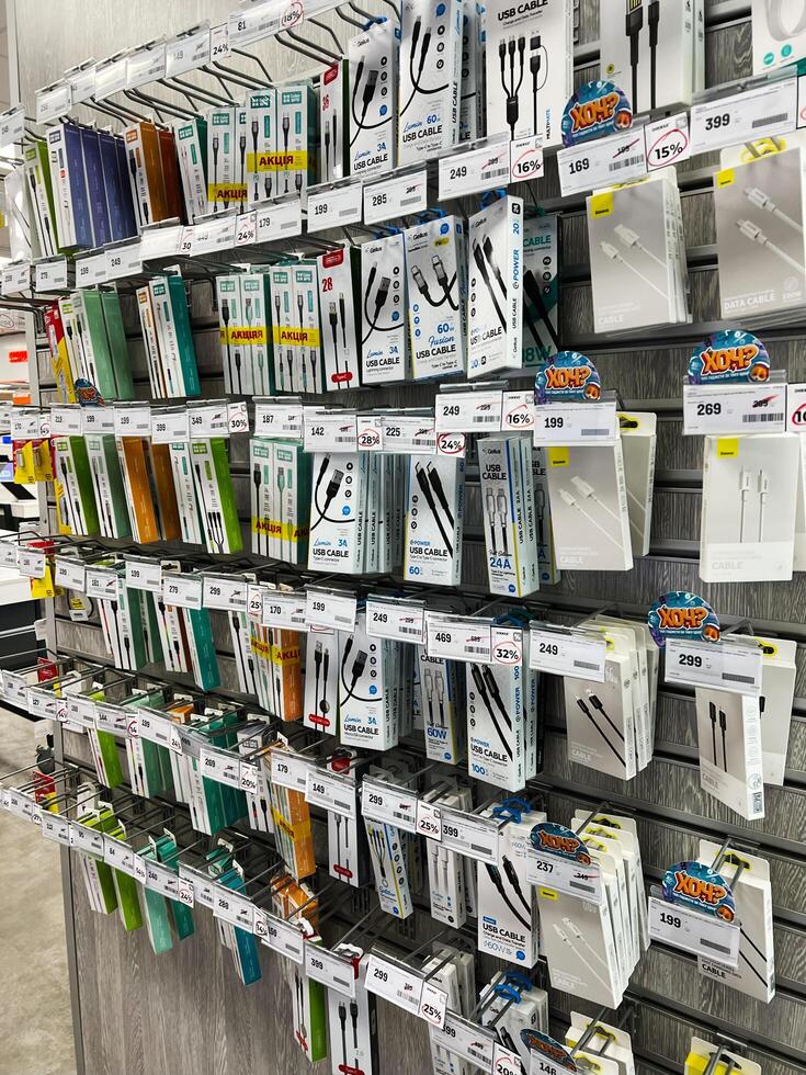 Kyiv, Ukraine - February 04, 2025 Display of USB cables in retail store with various models and prices visible photo