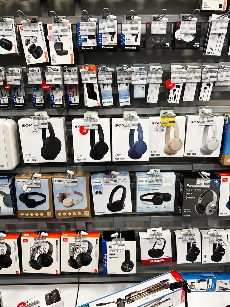Kyiv, Ukraine - February 04, 2025 Display of Headphones and Earbud Packaging in Electronics Store photo