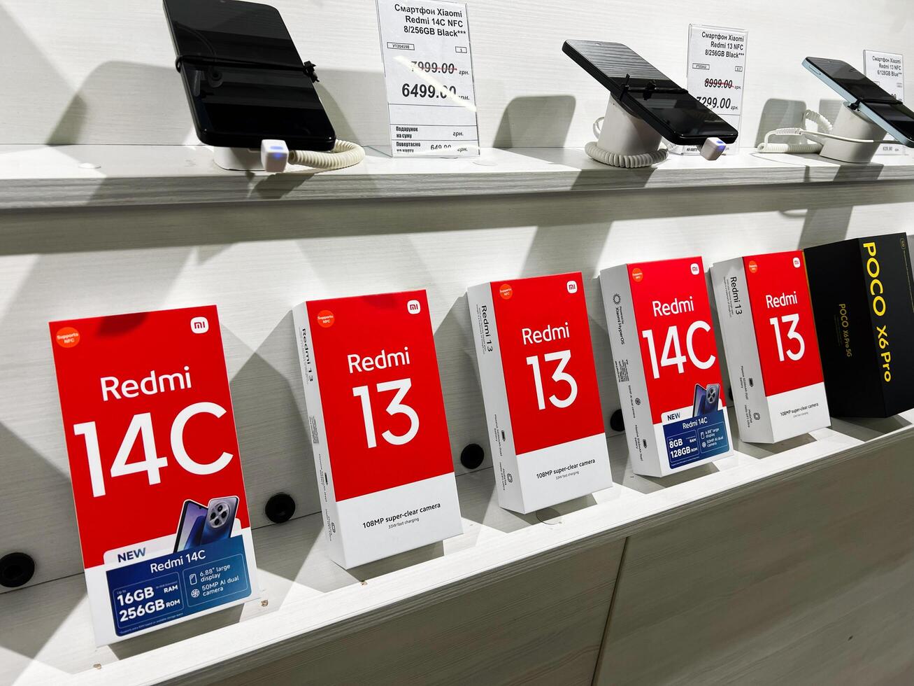 Kyiv, Ukraine - February 04, 2025 Display of Redmi 14C and 13 Smartphones in Retail Electronics Store photo