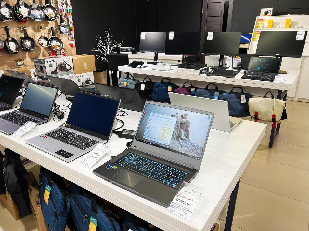 Kyiv, Ukraine - February 04, 2025 Modern laptop store with various models displayed for sale on tables photo