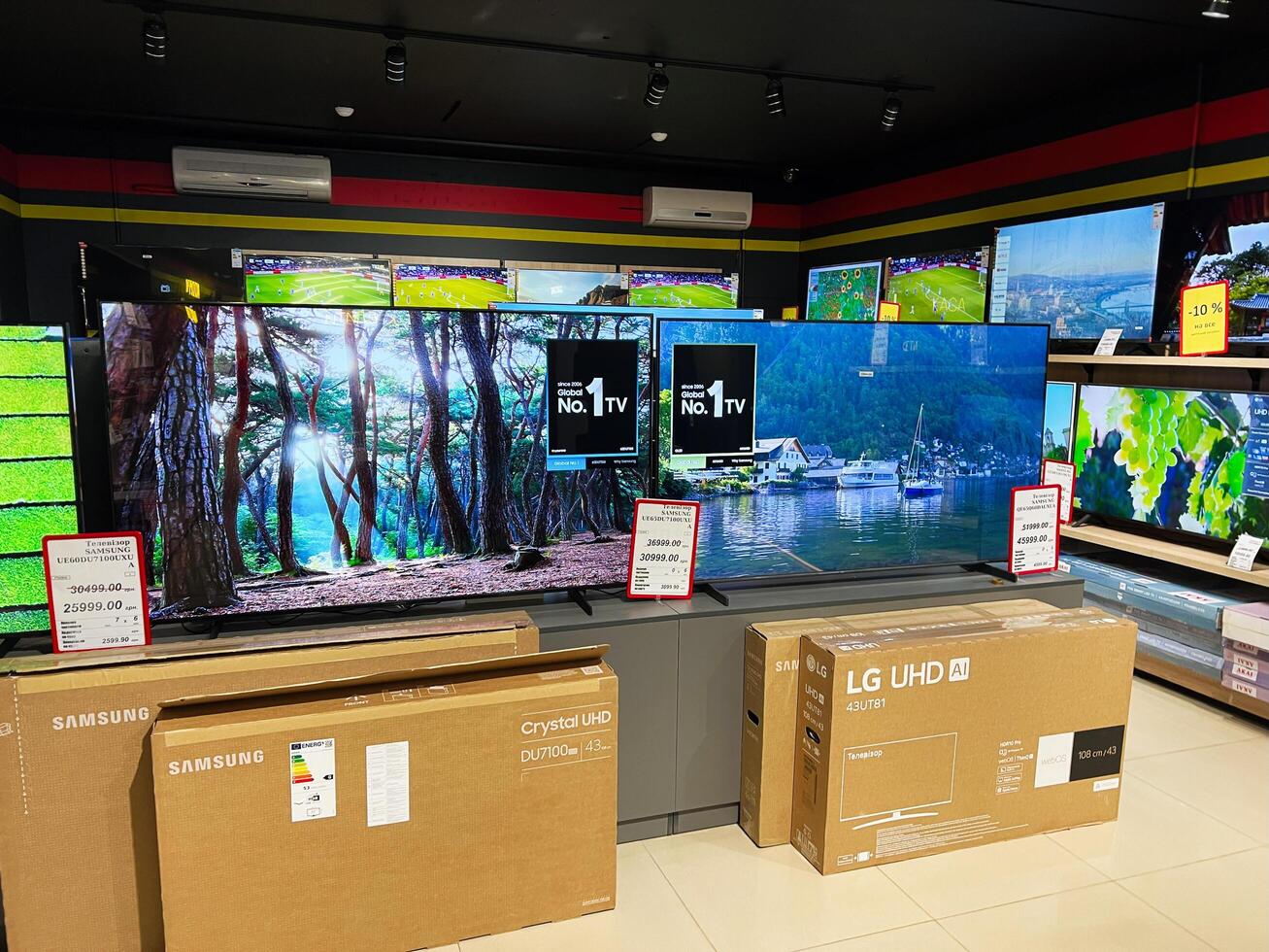 Kyiv, Ukraine - February 04, 2025 Electronics store with large flat-screen TVs on display and packaged televisions in boxes photo