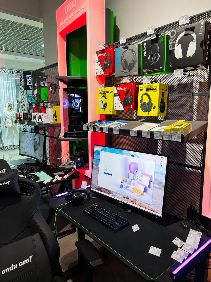 Kyiv, Ukraine - February 04, 2025 Gaming setup with headset display in electronics store interior photo