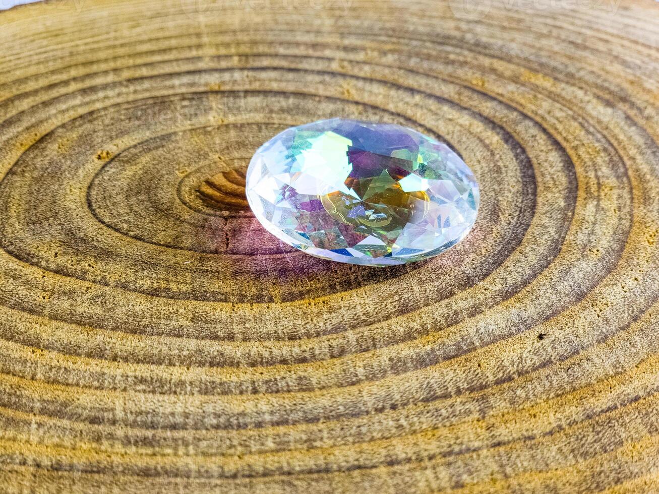 Processed quartz crystal on a wooden background photo