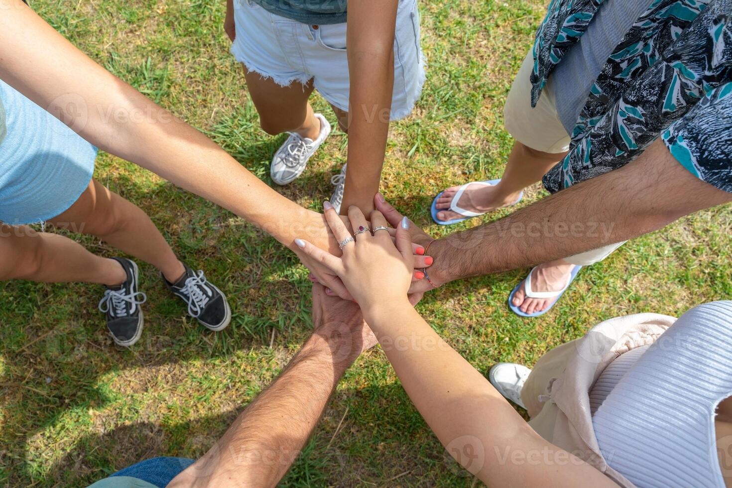 Teamwork, unity concept, group of friends put their hands together. photo