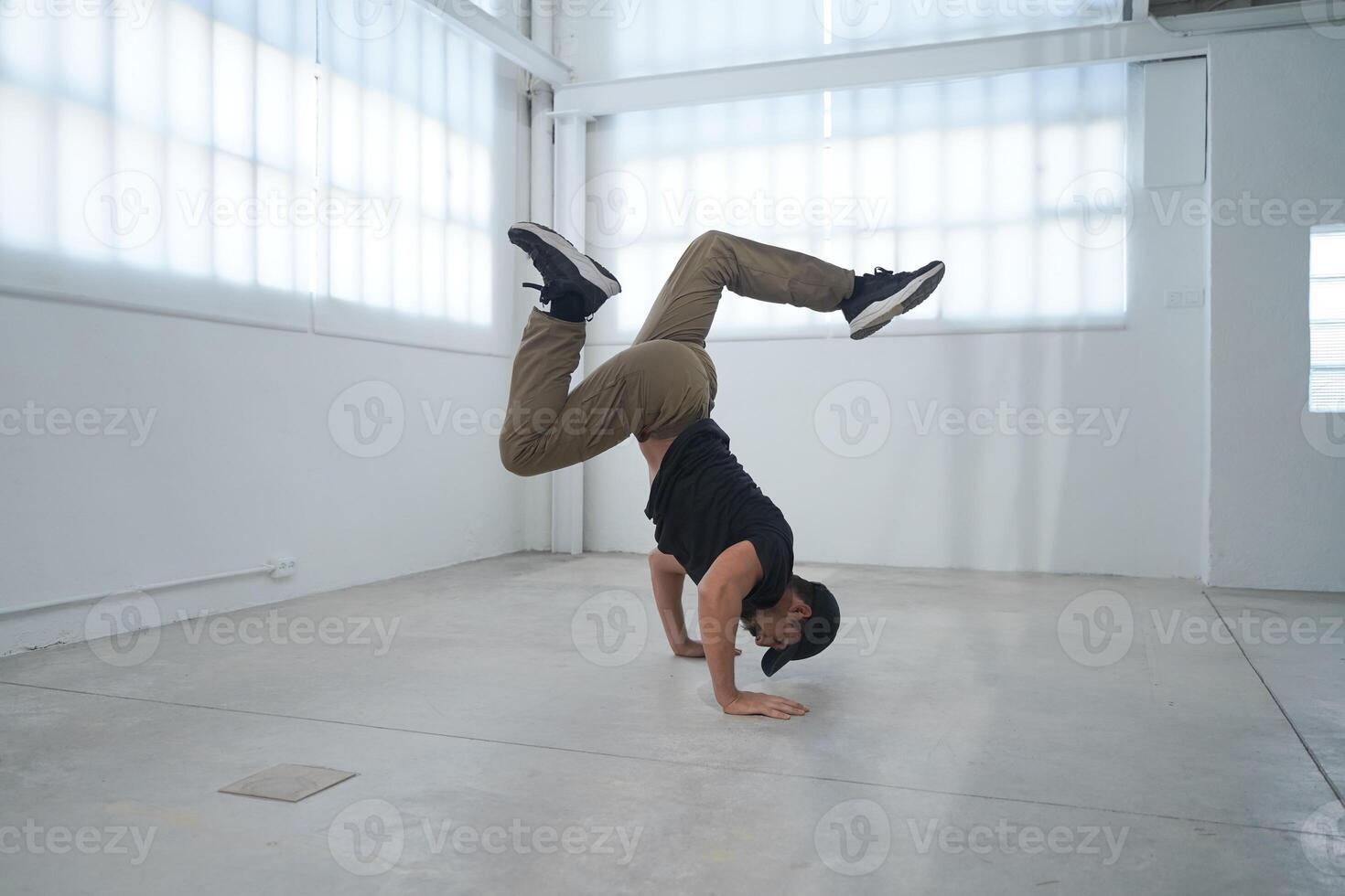 Happy man practice break dance freestyle. Professional b-boy dancer perform energetic movement photo