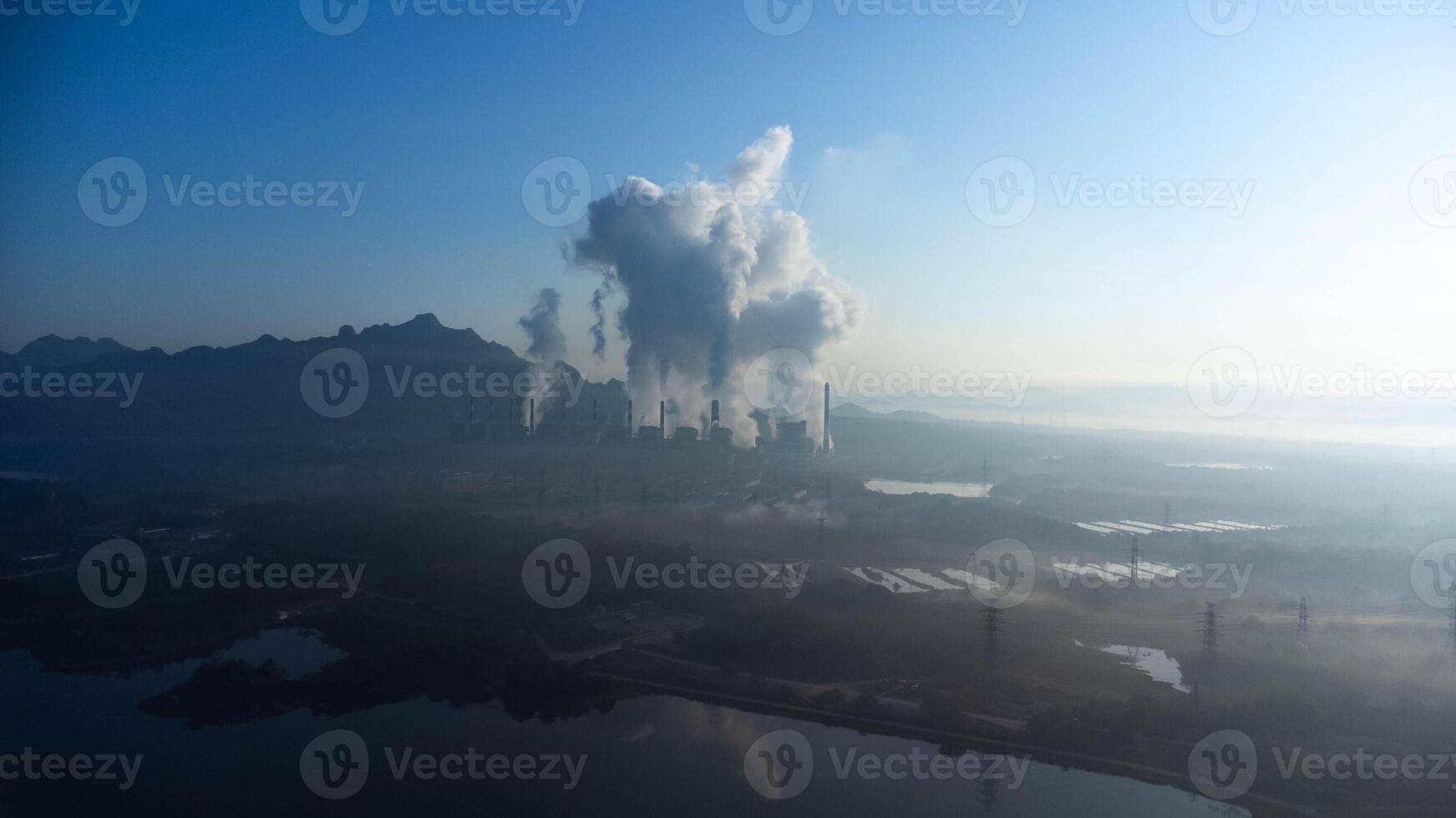 Aerial view of a coal-fired power plant with steam flowing out of the stack in the morning. Mae Moh Power Plant. photo
