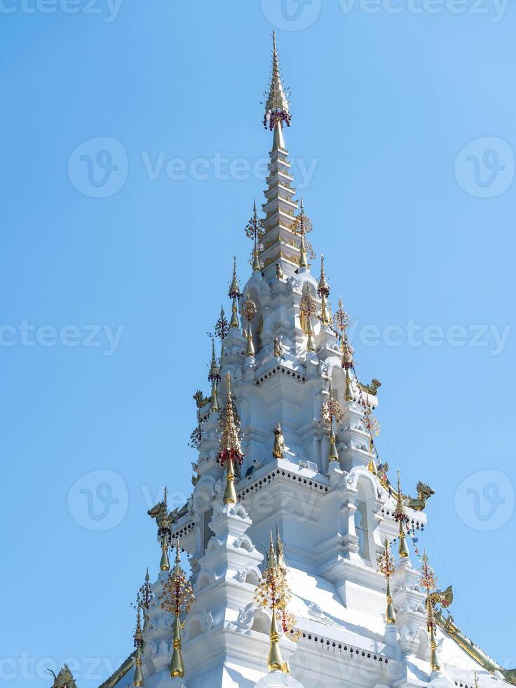 White and gold pagoda on a clear sky. photo