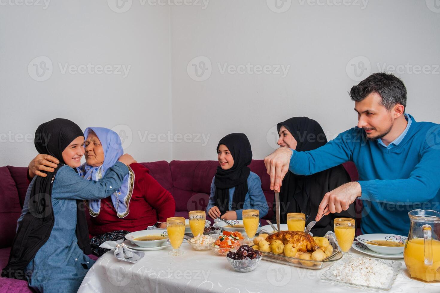 Happy Muslim family having iftar dinner during Ramadan dining table at home. photo