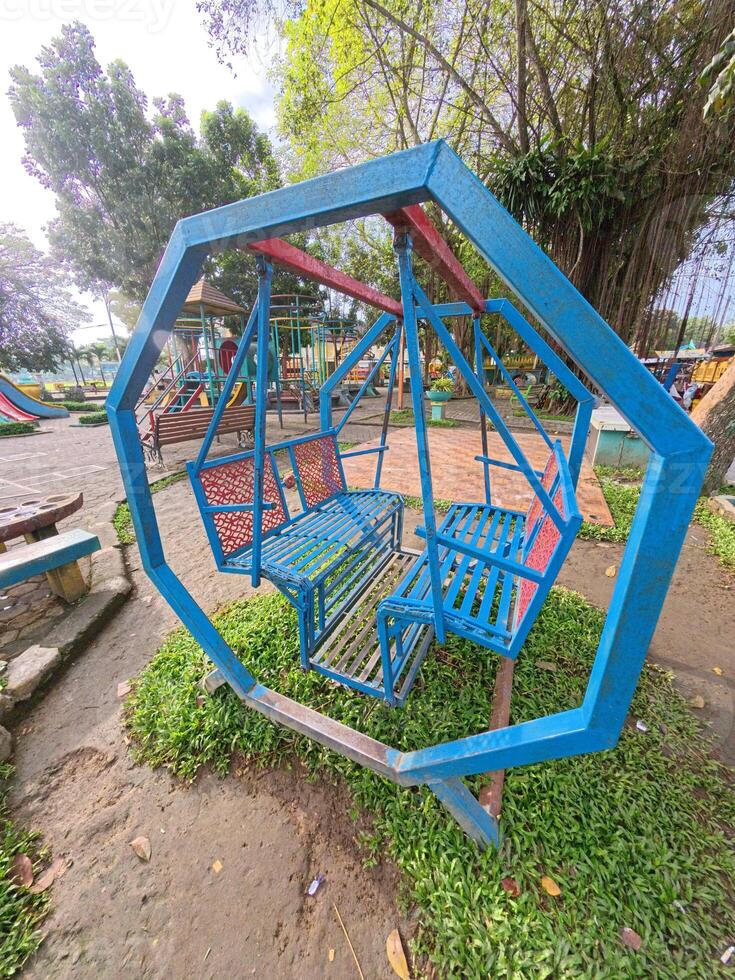 Unique Blue Swings in Vibrant Community Playground photo