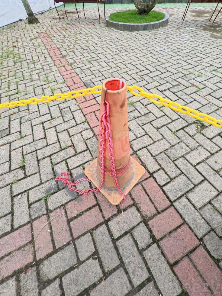 Traffic Cone with Chains on Paved Surface photo