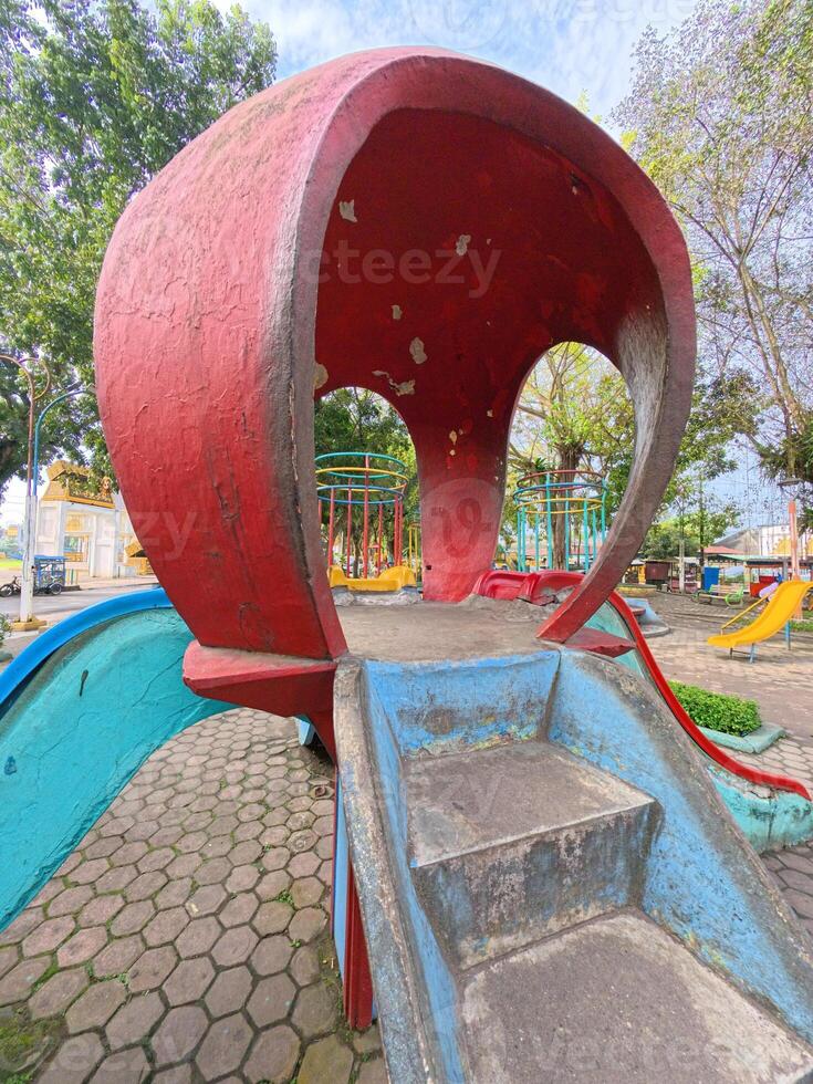 Colorful Playground Slide with Stone Steps Attached photo