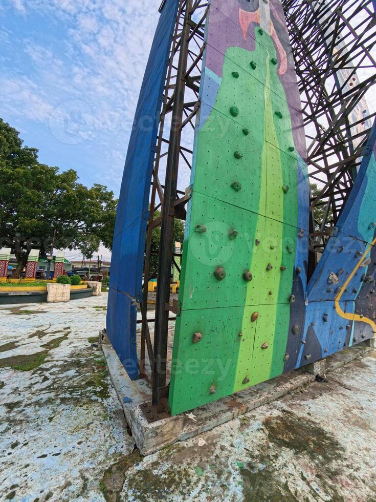 Colorful Big Rock Climbing Wall with Handholds photo